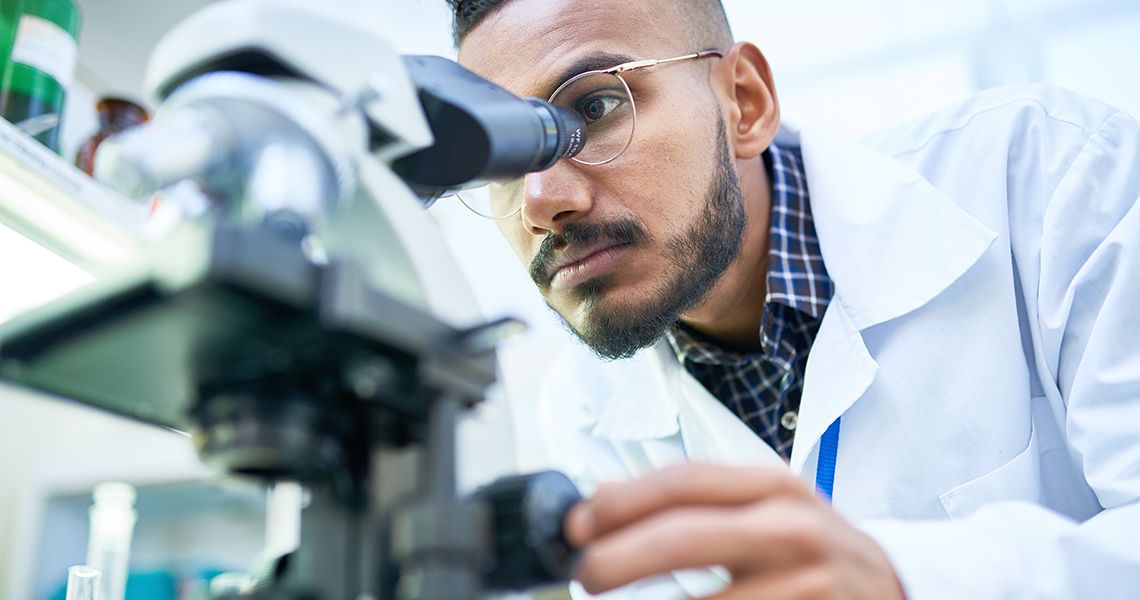 Scientist Using Microscope in Laboratory 