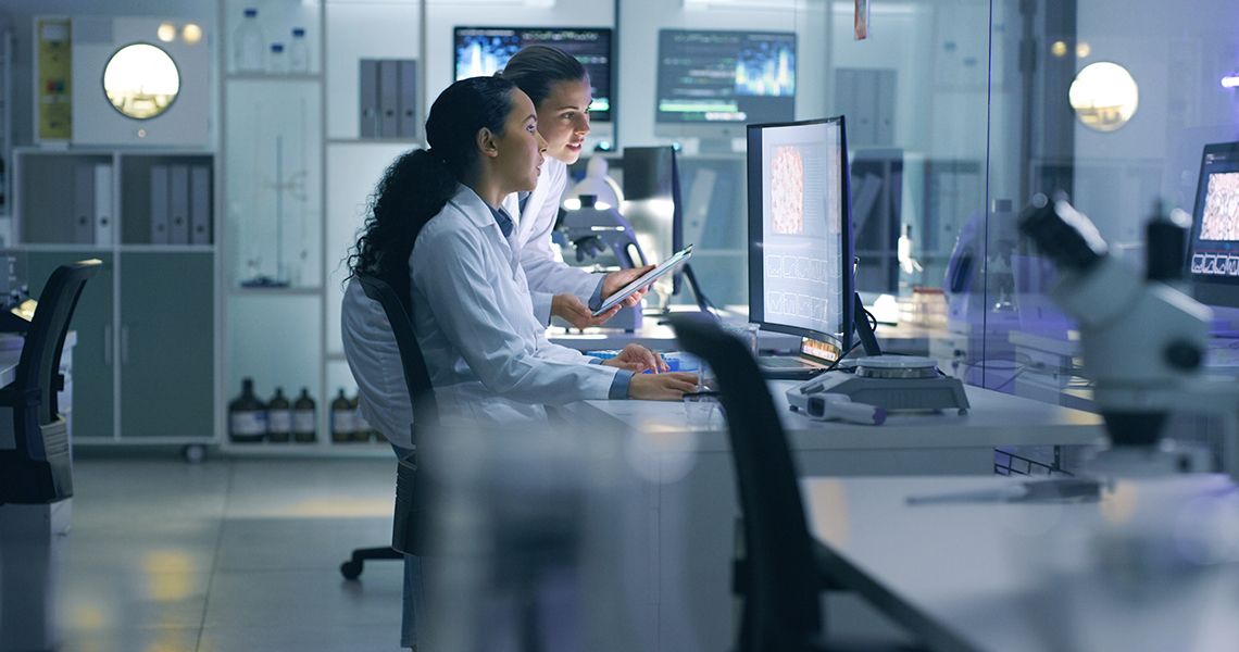 medical scientists analyzing research scans on a computer